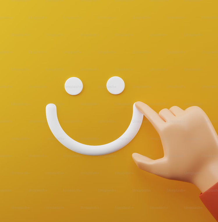 a finger pointing at a smiley face